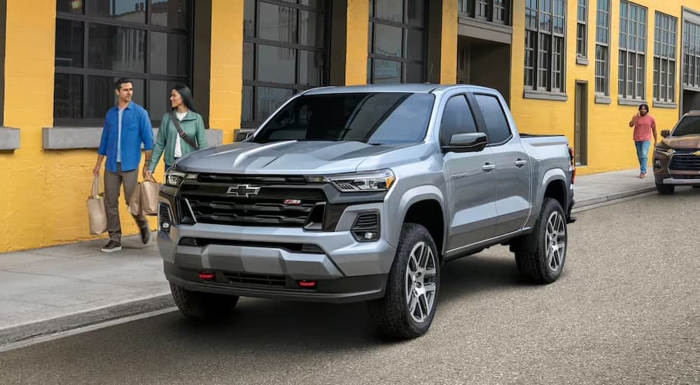 A silver 2023 Chevy Colorado parked in a city.