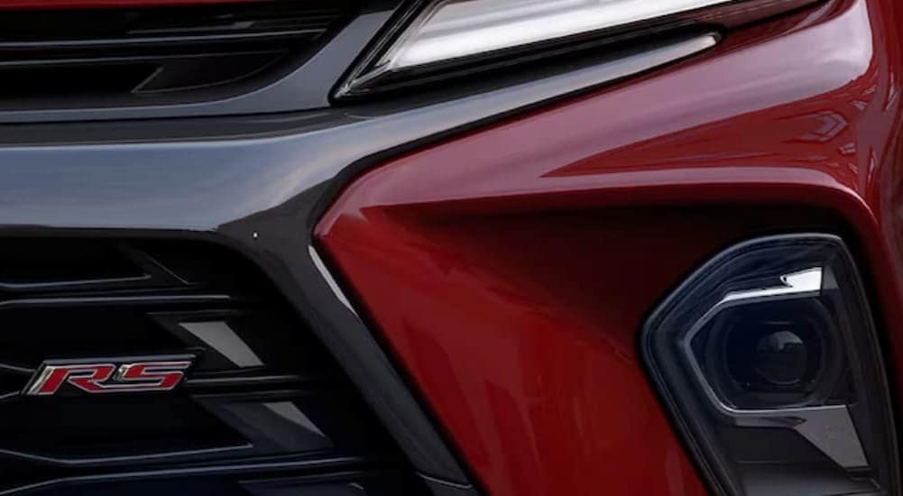 A close-up of the front end of a red 2024 Chevy Blazer Rs is shown.