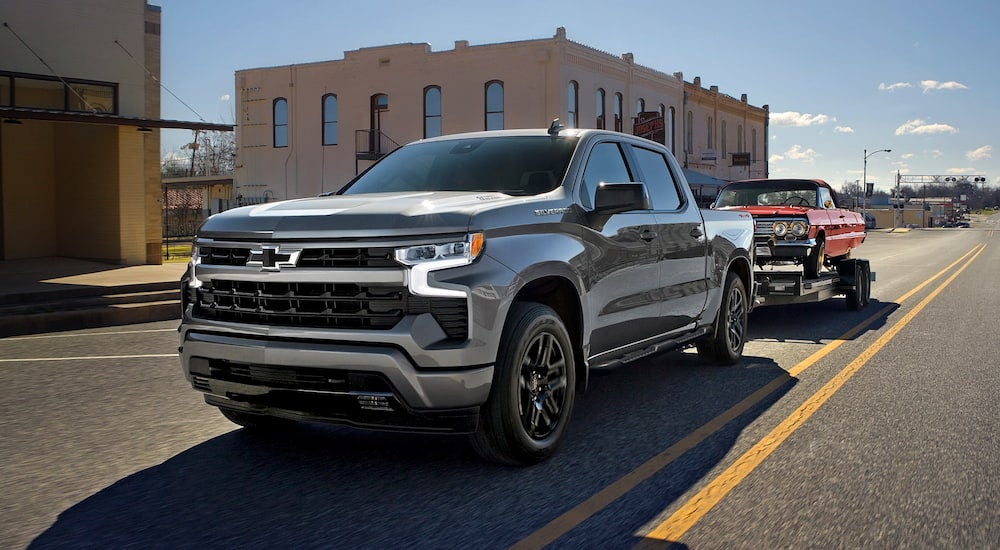 Grey 2026 Chevy Silverado 1500 driving down an open road.