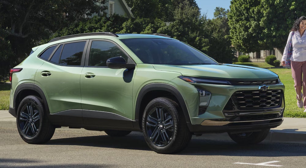 A green 2025 Chevy Trax parked by a field.
