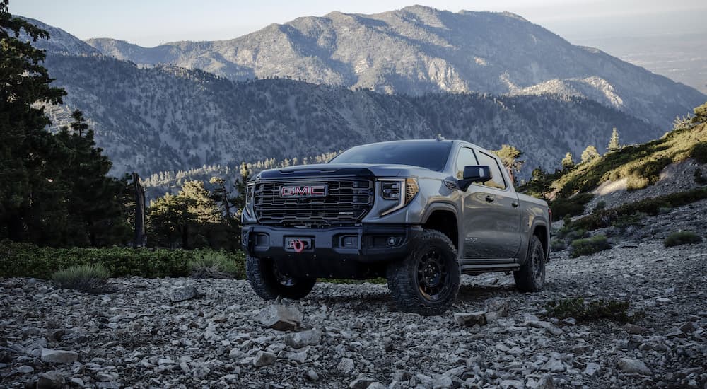 A grey 2025 GMC Sierra 1500 AT4x AEV parked off-road.