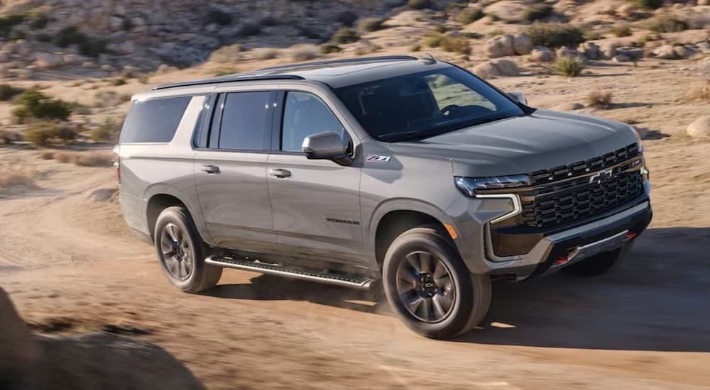 A gray 2023 Chevy Suburban off-roading.