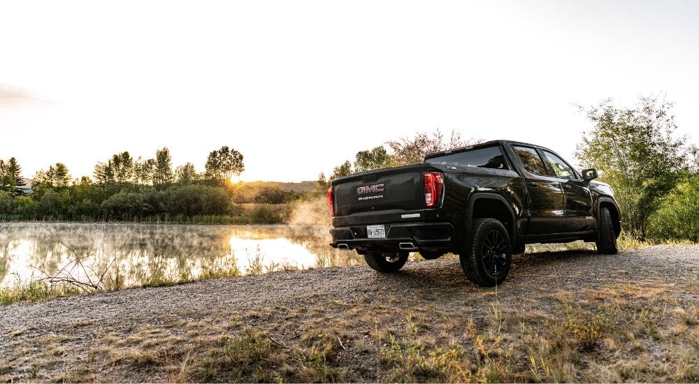 A black 2025 GMC Sierra 1500 Elevation parked off-road.