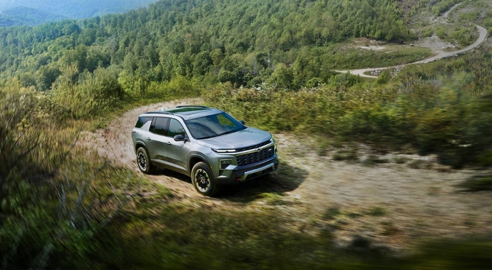 Overhead view of a silver 2024 Chevy Traverse Z71 driving on a mountain path.
