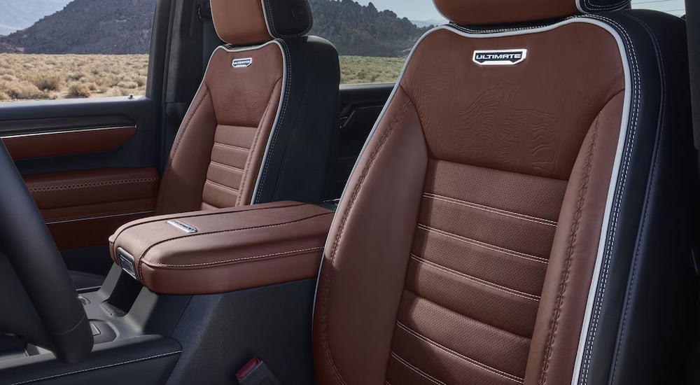 The brown leather front seats in a 2024 GMC Sierra 3500 Ultimate HD for sale.
