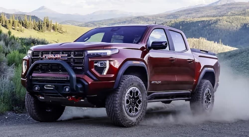 A red 2023 GMC Canyon AT4X driving offroad.