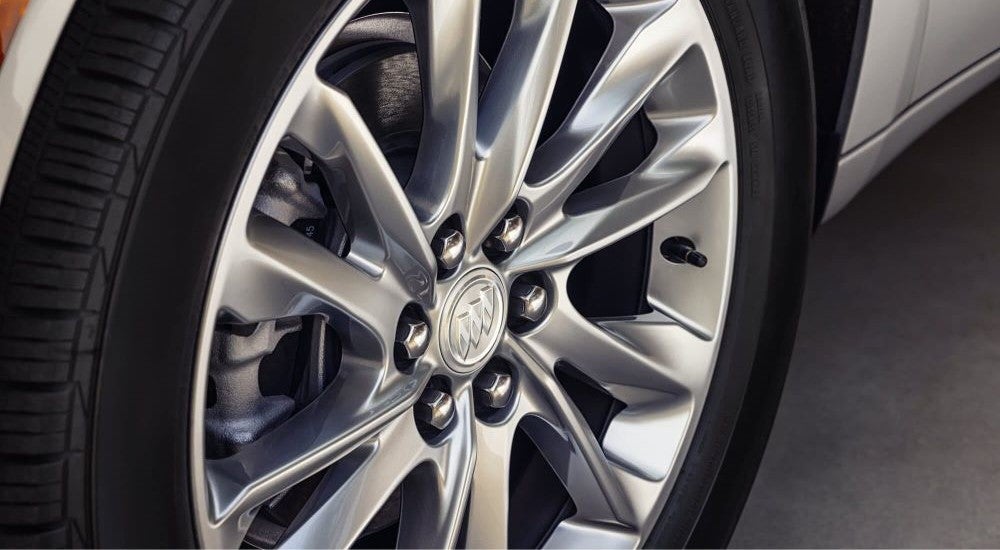 The wheel and tire on a silver 2023 Buick Enclave.
