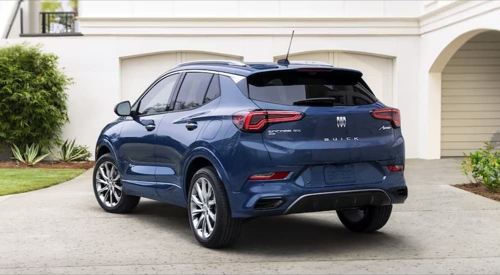 A blue 2023 Buick Encore GX shown parked in a driveway from the rear.