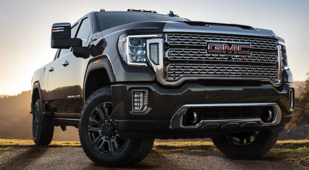 A black 2024 GMC Sierra 3500 HD parked off-road.