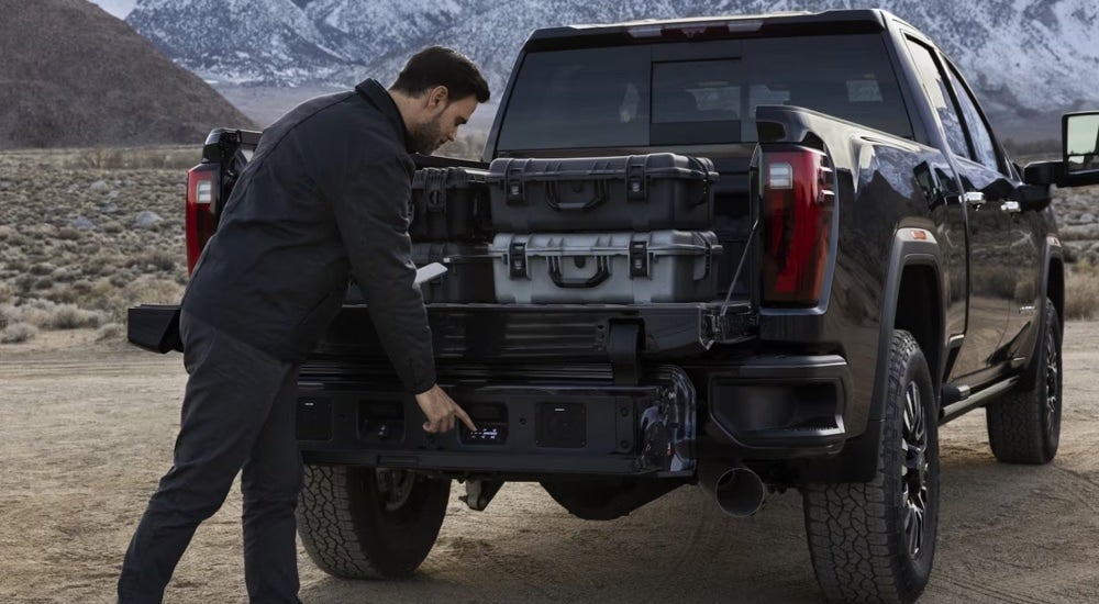 An open MultiPro tailgate on a black 2024 GMC Sierra 3500 Denali HD.
