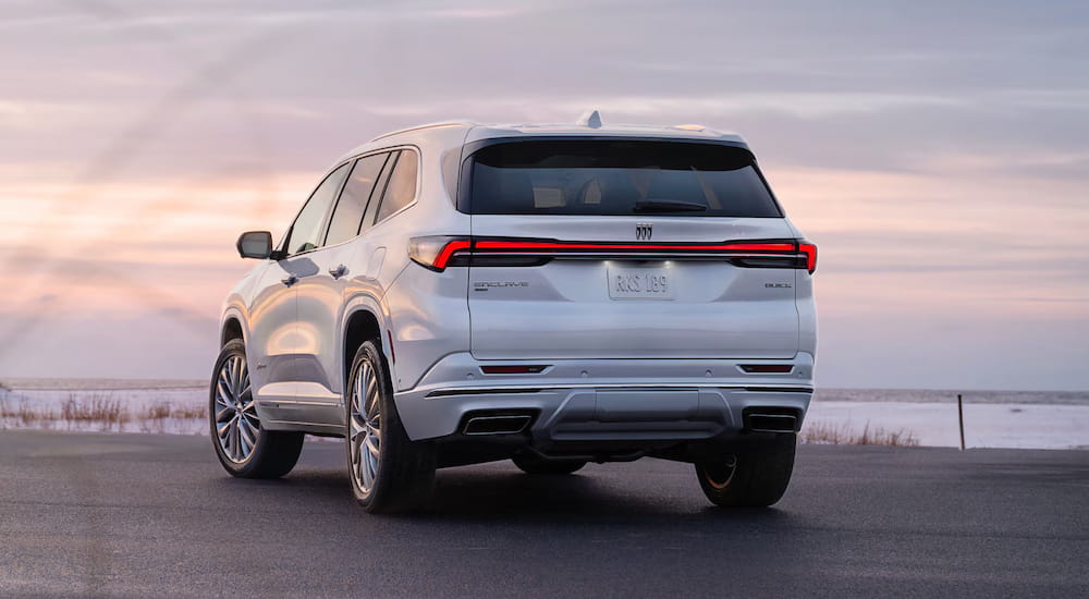 A white 2025 Buick Enclave parked by a Buick dealer near Detroit.