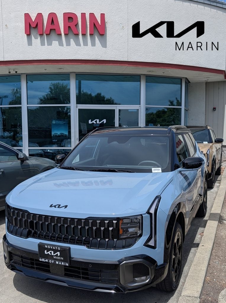 Front quarter view of the 2027 Kia Seltos X-Line S AWD in two-tone Frost Blue with a black roof parked at the Kia of Marin dealership