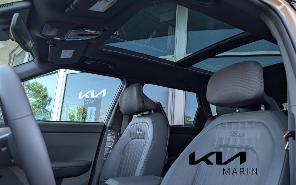Interior view looking up through the all-new panoramic moonroof in the 2027 Kia Seltos