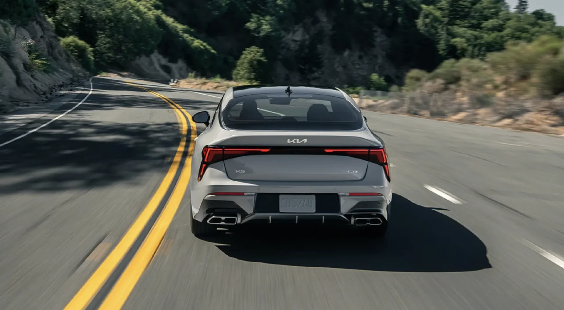 Quad-tip dual exhaust shown on the Kia K5 GT in Wolf Gray.