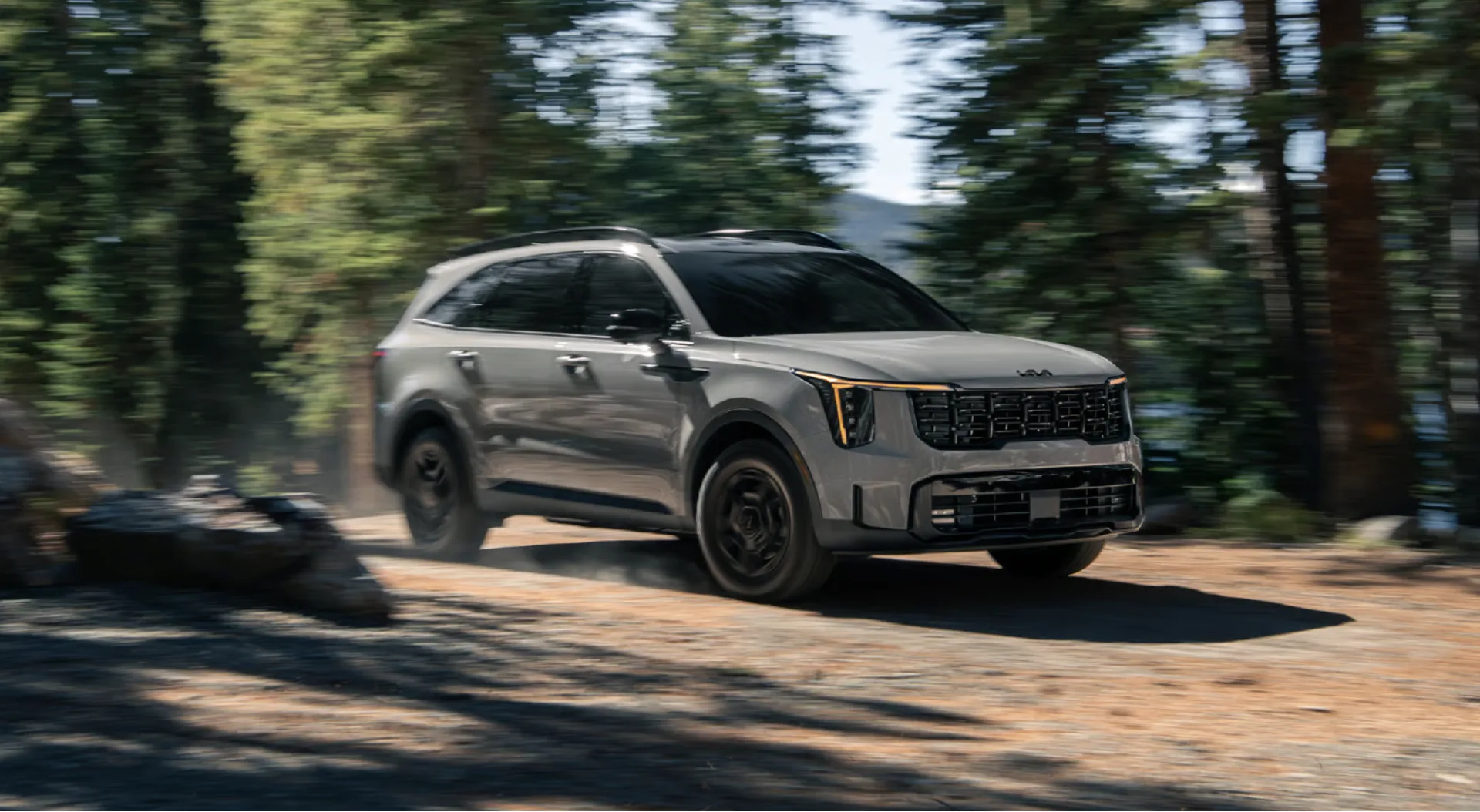 2026 Kia Sorento X-Pro SX Prestige shown with gloss black themed appearance and amber daytime running lights (DRLs)
