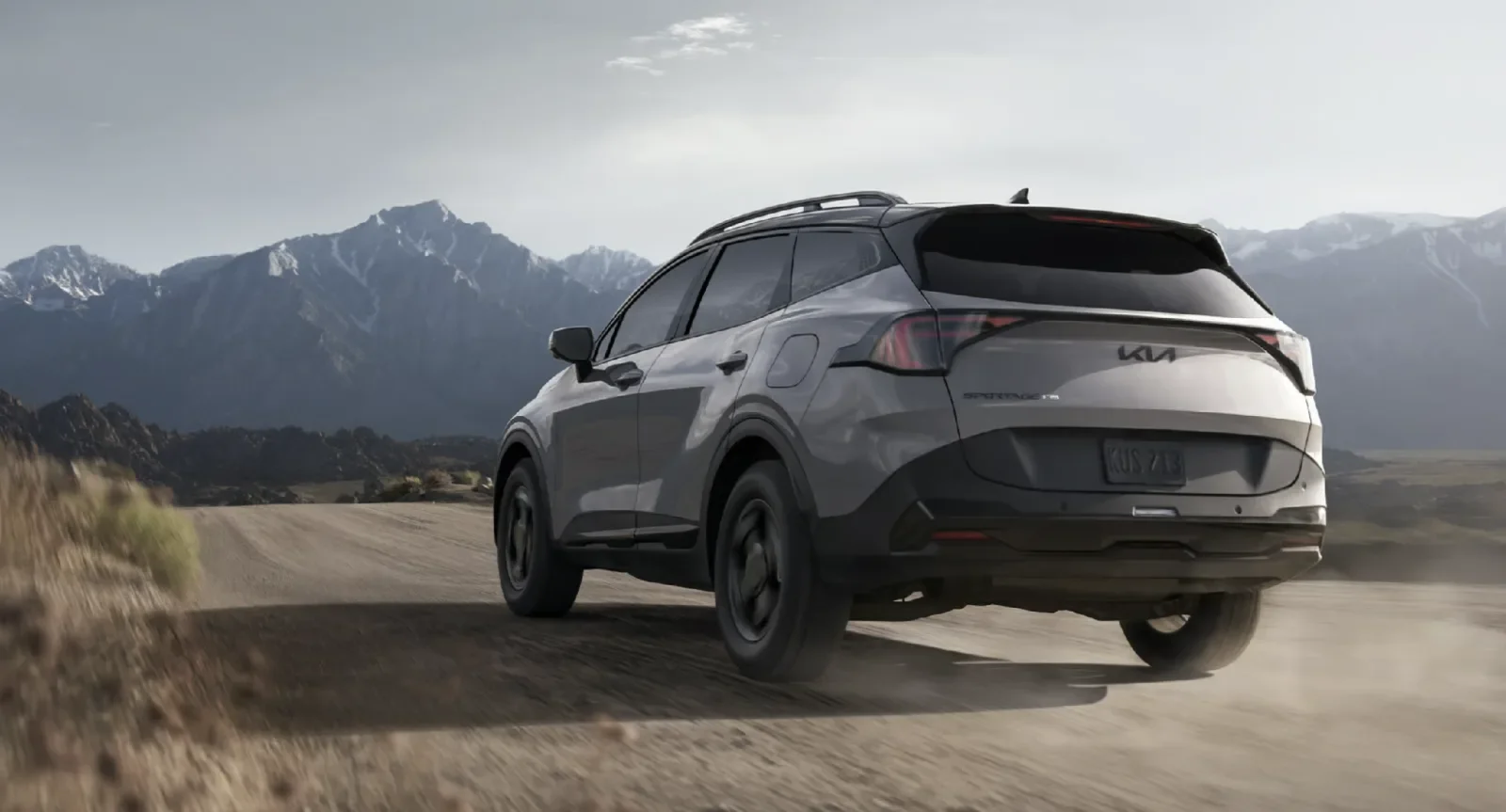 The 2027 Kia Sportage X-Pro Prestige shown in Wolf Gray with black wheel arch molding and rear spoiler
