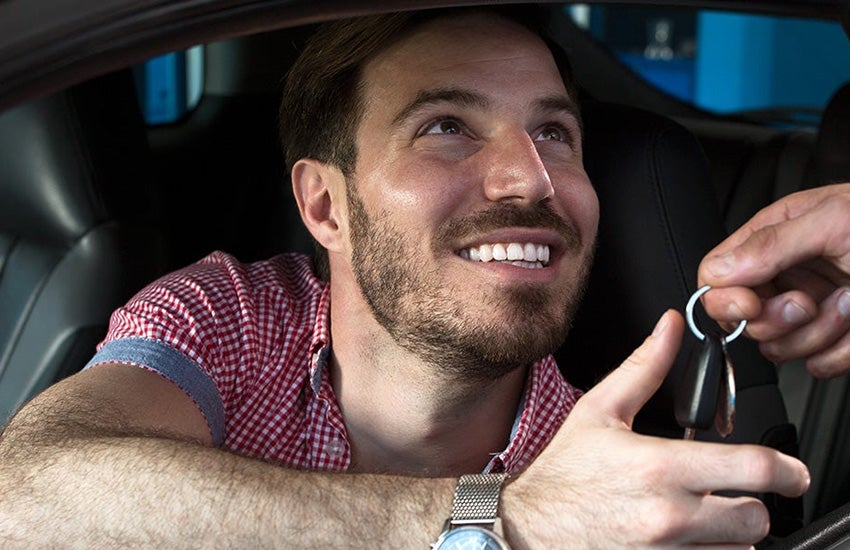 Man takes car keys from dealer