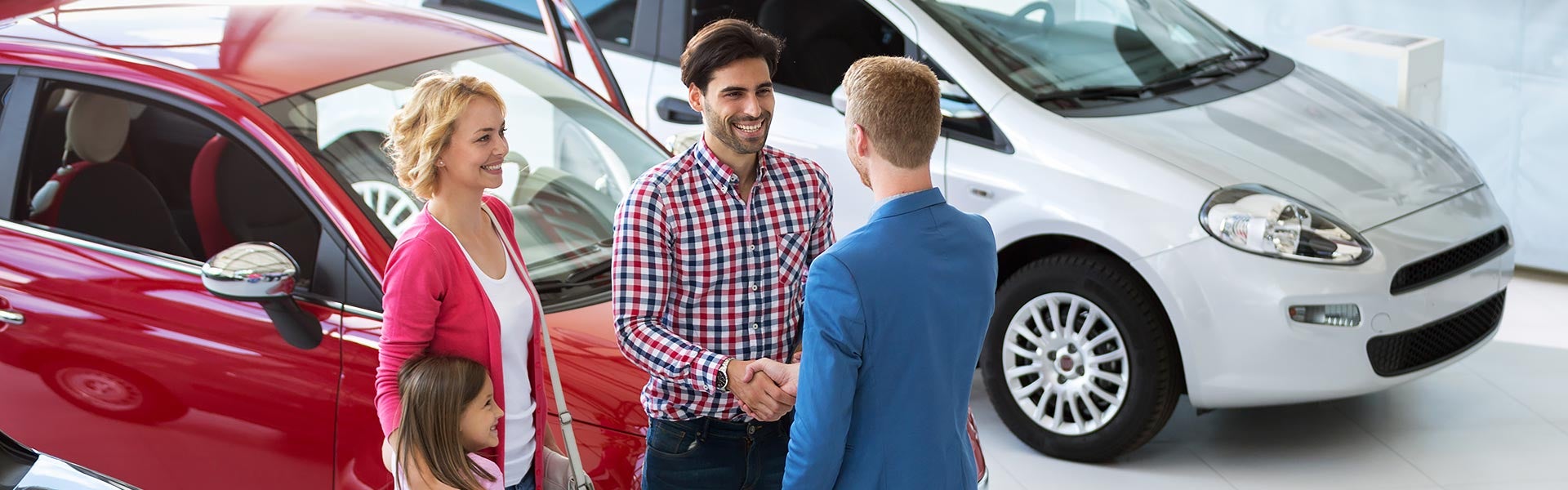 Sales person explaining about car to the customers.