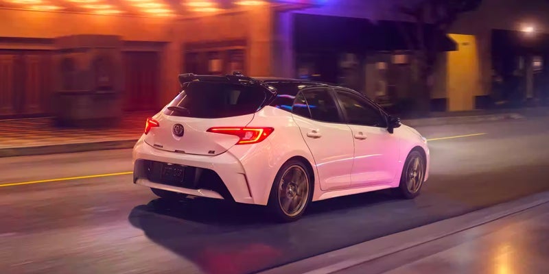 A 2024 Toyota Corolla Hatchback driving down a road in Kent, OH 