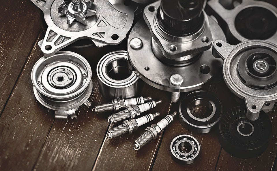 A pile of new car parts on a table. 