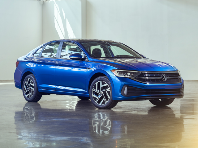 A blue Volkswagen Jetta Sport on the showroom floor. 