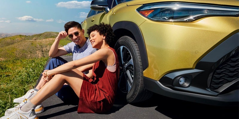 A couple hanging out after taking a drive in their 2024 Toyota Corolla Cross Hybrid near Pleasant Hills, PA 