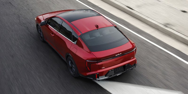 Red Kia K4 on road