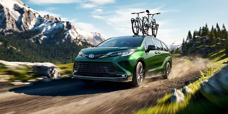 A 2024 Toyota Sienna off-roading and set up with a bicycle rack in Akron, OH