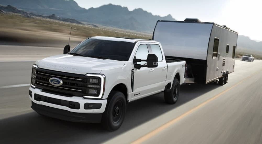 A white 2026 Ford F-350 towing a trailer.