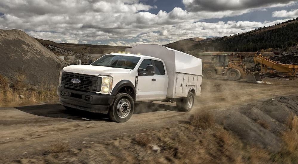 A white 2026 Ford F-450 driving offroad.