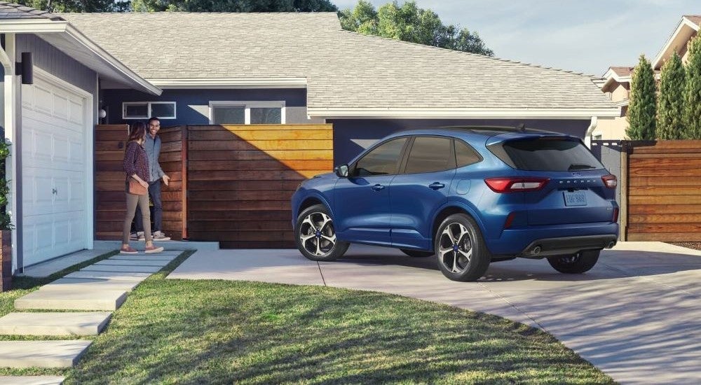 A blue used 2023 Ford Escape for sale parked in a driveway