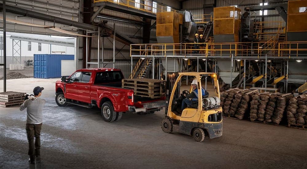A red 2027 Ford Super Duty parked in a warehouse.