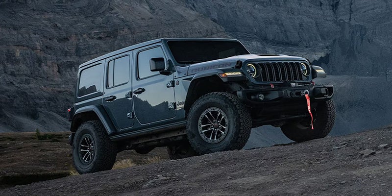 A Jeep Wrangler Rubicon four-door driving off-road