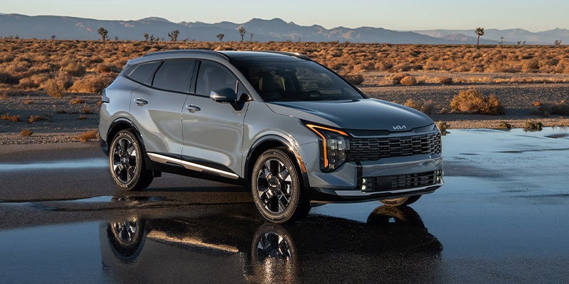 A grey Kia Sportage Hybrid parked off-road