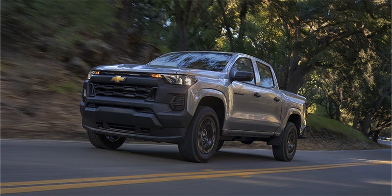A silver Chevrolet Colorado truck on the road.