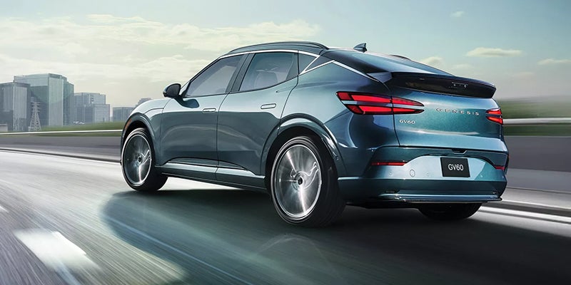 A Genesis GV60 electric SUV in a teal blue exterior color.