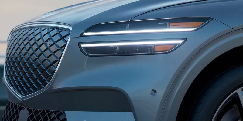 An all-new Silver 2024 Genesis Electrified GV70 grill and headlight. - Genesis of Baton Rouge, LA