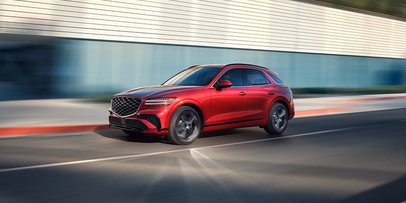 A Genesis GV70 SUV shown in a vibrant red exterior
