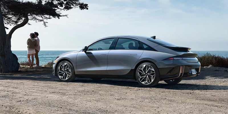 A silver Hyundai IONIQ 6 sedan parked near the ocean