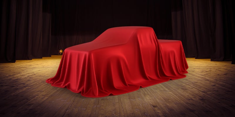 A Toyota truck hidden under red covers.