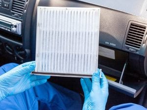 Service Technician removing the cabin air filter.