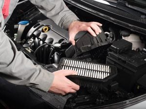 Service Technician removing the engine air filter.