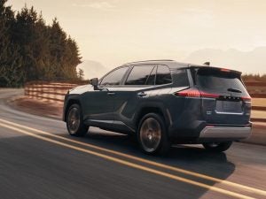 Toyota RAV4 driving down a country road.