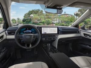 2026 Toyota Camry Hybrid interior, showing steering wheel and center console.