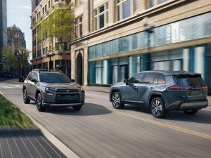 Toyota RAV4 driving on a city street, passing by another RAV4.