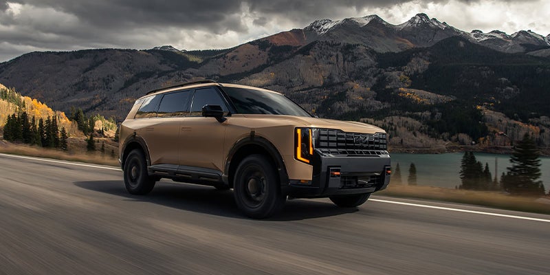 A Kia Telluride sporting the Terrain Brown Matte exterior color on the road.