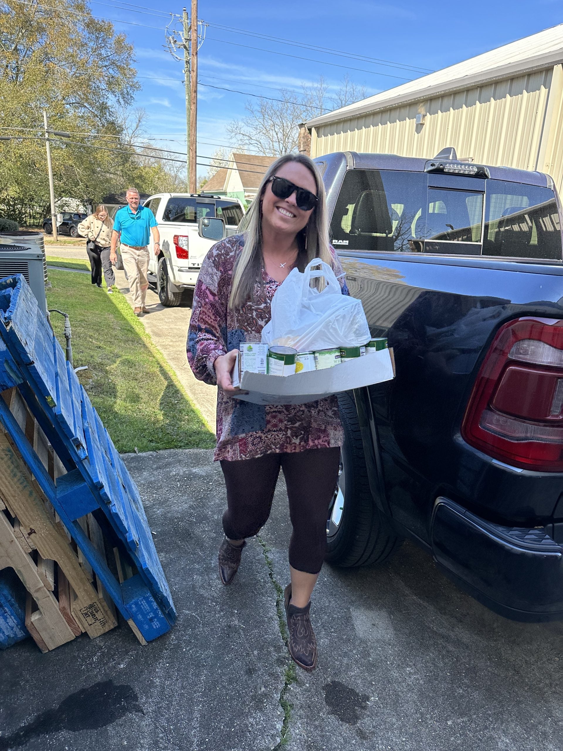 Jessica with Mitchell Nissan unloading food drive donations at the Christian Mission