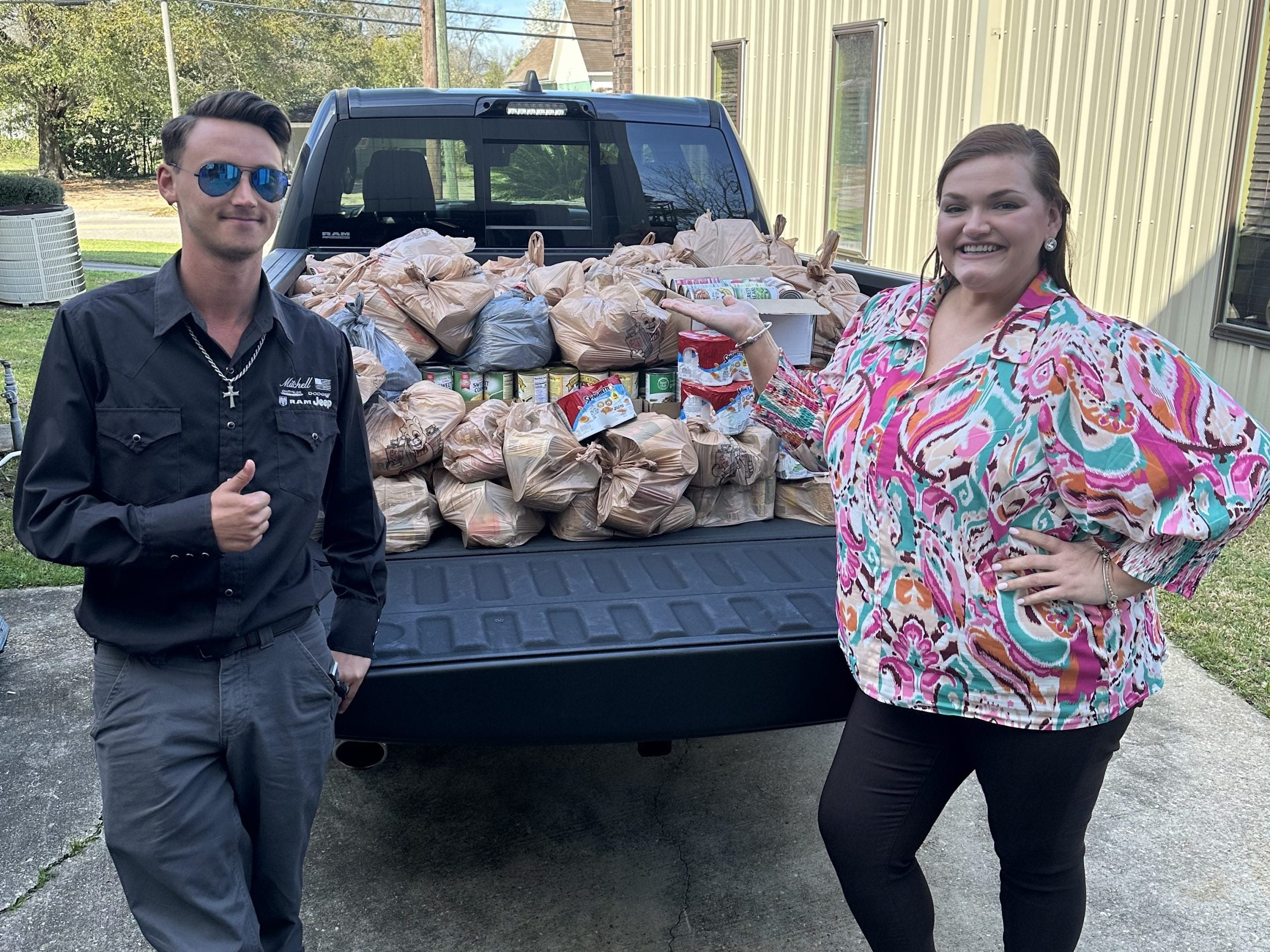 Mitchell CDRJ unloading food drive donations at the Christian Mission
