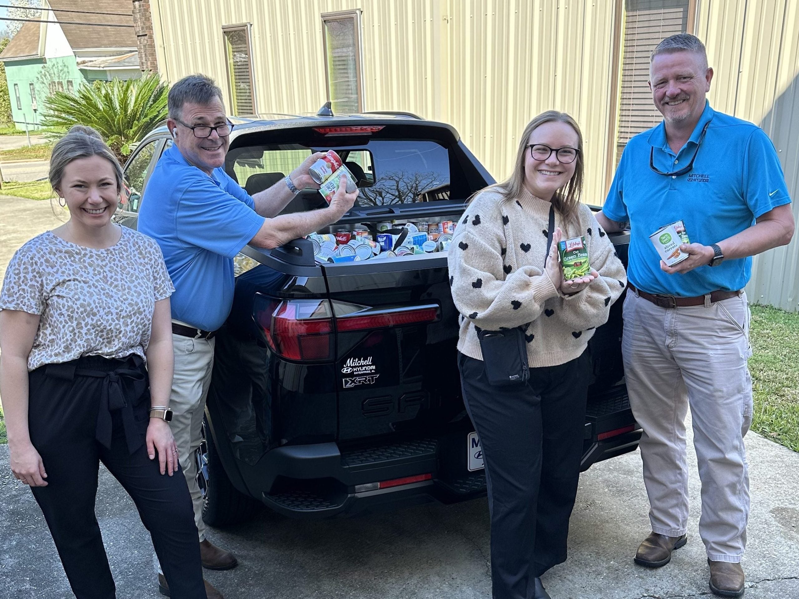 Mitchell Hyundai unloading food drive donations at the Christian Mission