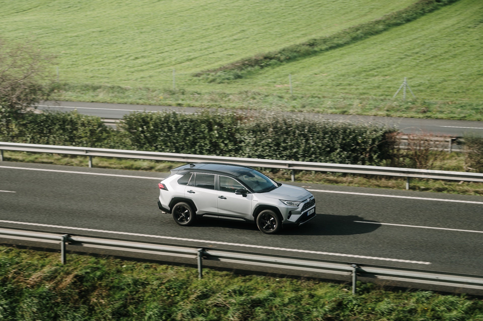 A Toyota RAV4 in motion on a highway